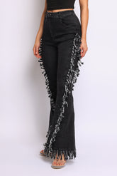Distressed fringe denim flared pant.