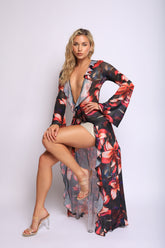 Black mesh top with bold red floral print, deep plunge neckline, and soft ruffle detailing