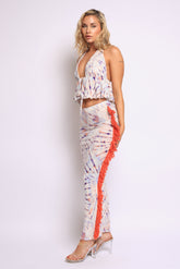 Vibrant tie-dye halter top with flared ruffle hem and side-trimmed matching skirt