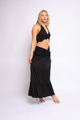 Flowy black two-piece set with plunging neckline and elastic waistband skirt