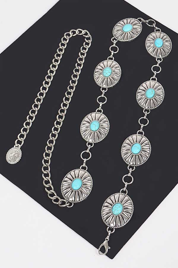 Silver western chain belt styled on mannequin with turquoise stone medallions

