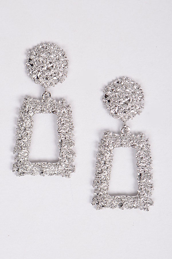 Sculptural silver earrings with hammered finish and geometric drop

