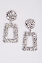 Sculptural silver earrings with hammered finish and geometric drop

