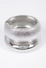 Silver hammered bangle with rounded dome shape and metallic finish

