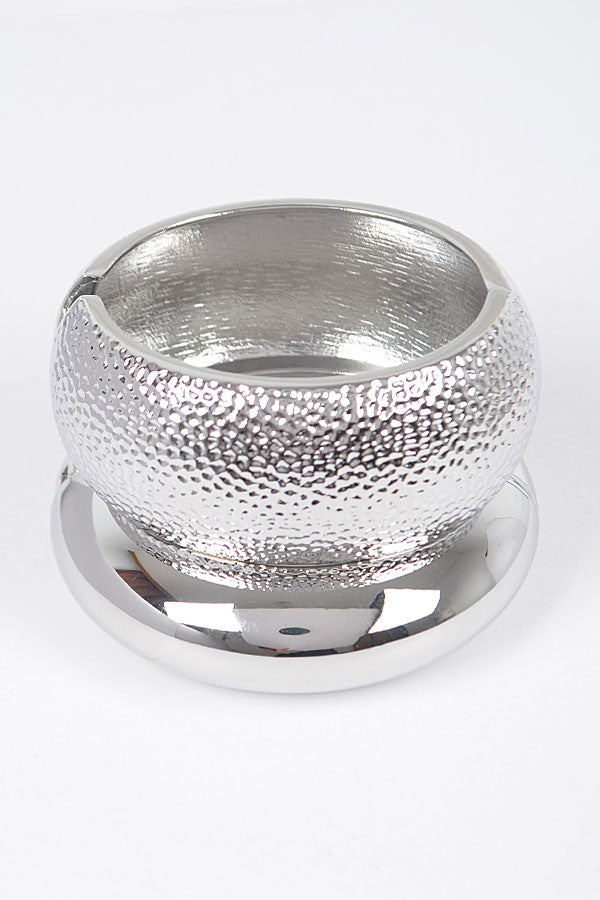 Silver hammered bangle with rounded dome shape and metallic finish

