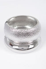 Silver hammered bangle with rounded dome shape and metallic finish

