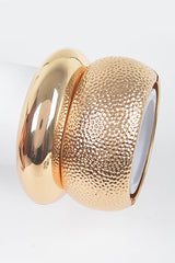 Chunky hammered gold bracelet with metallic shine and bold structure

