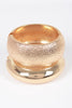 Gold hammered bangle with domed shape and textured metallic finish

