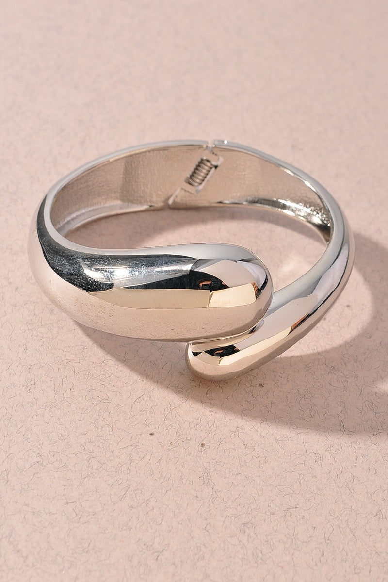 Silver curved cuff bracelet with abstract sculptural silhouette

