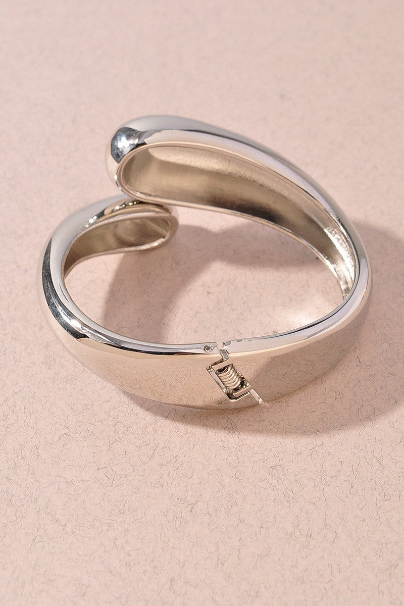Glossy silver metal bangle with high-polish minimalist design

