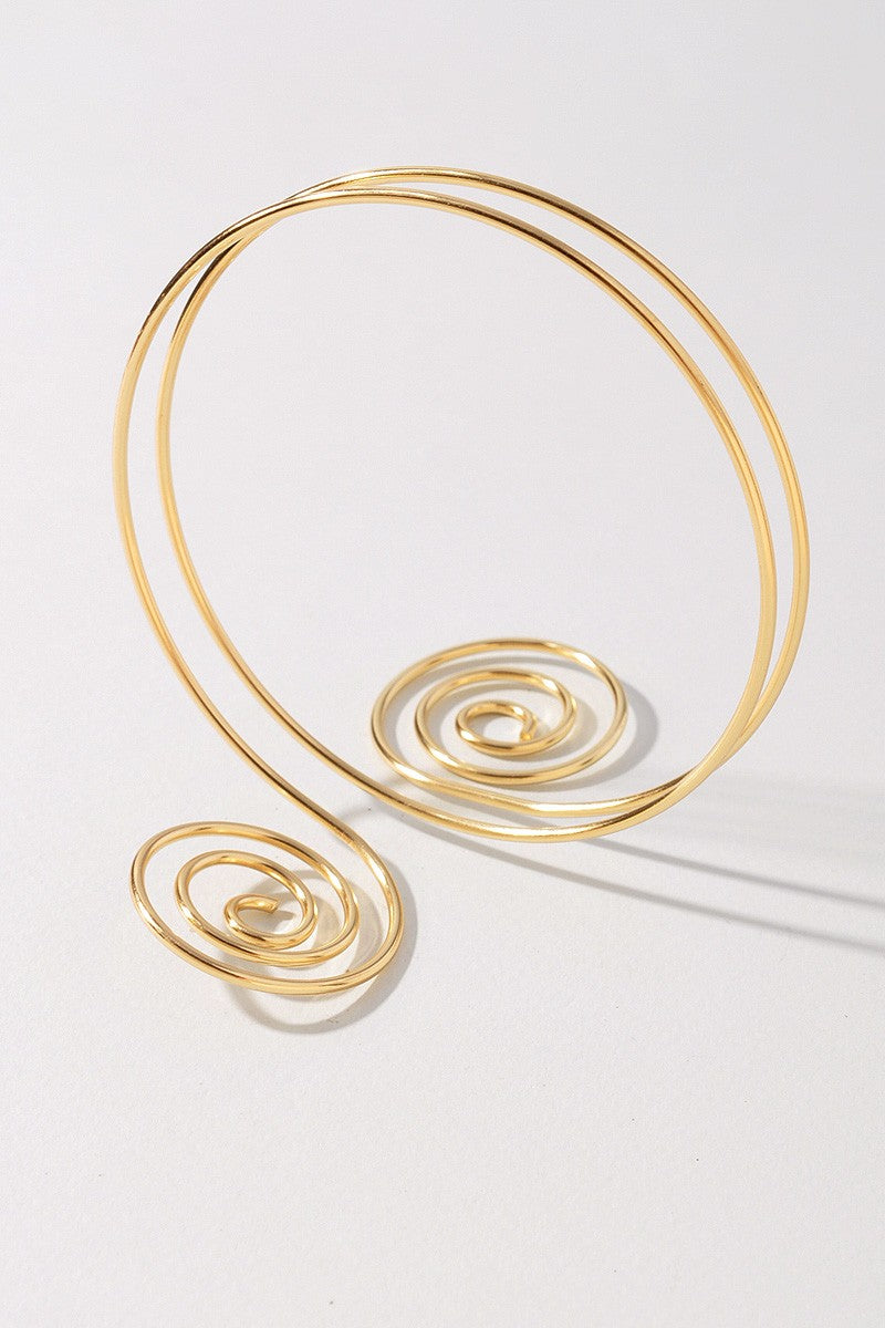 Curved gold-tone metal bicep cuff with coiled spiral detailing

