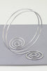 Silver spiral arm cuff with twin swirl shape and open wire wrap

