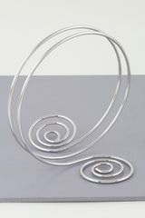 Silver spiral arm cuff with twin swirl shape and open wire wrap

