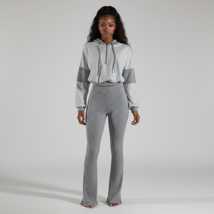 Front view of gray ribbed knit hoodie set with zip-up crop top and matching flare pants