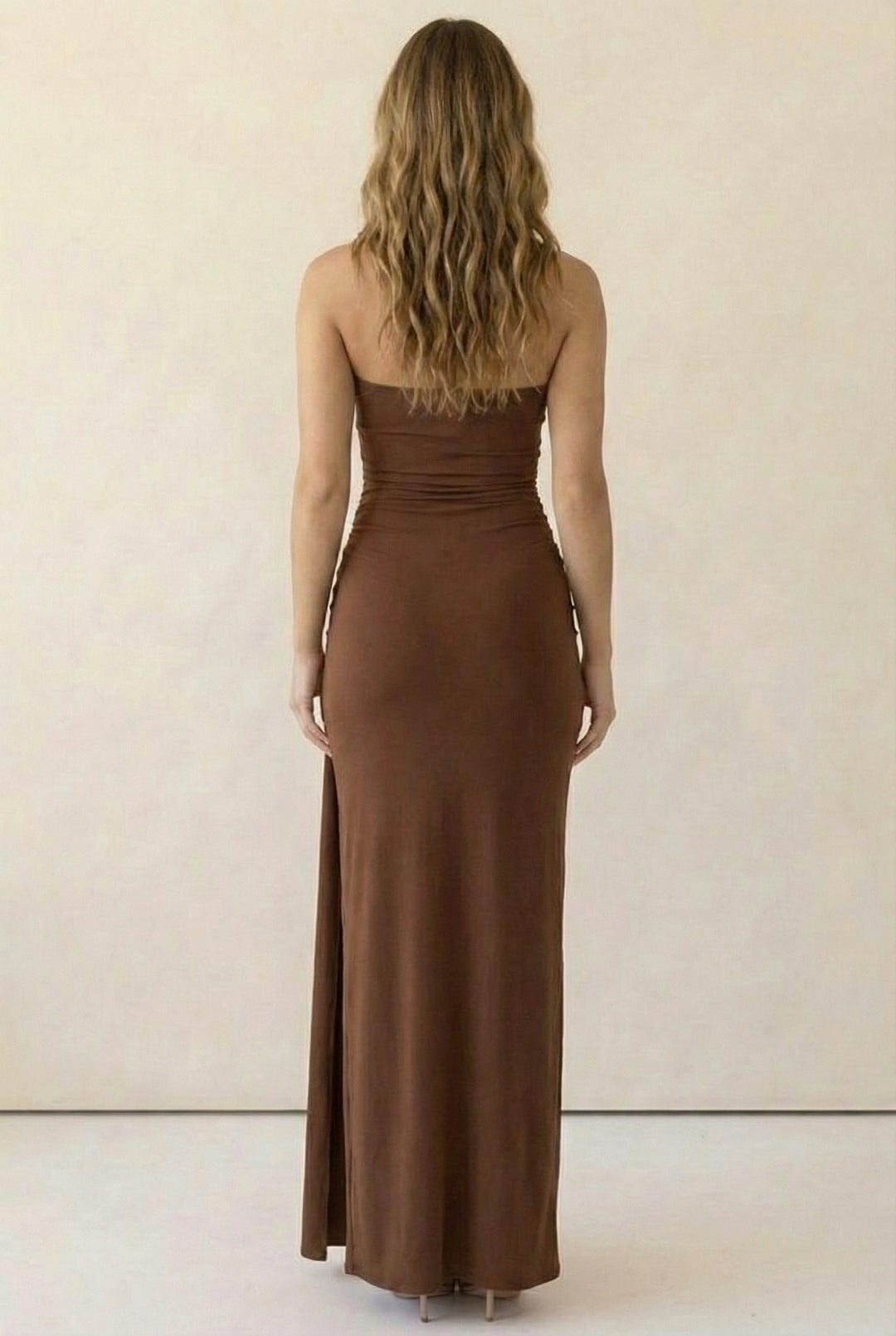 Back view of brown bodycon strapless maxi dress with smooth stretch fabric and clean silhouette; hugs curves for all-day comfort