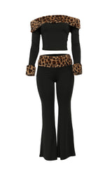 Black outfit with leopard print accents on a white background