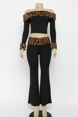 Mannequin wearing a black outfit with leopard print accents on a white background