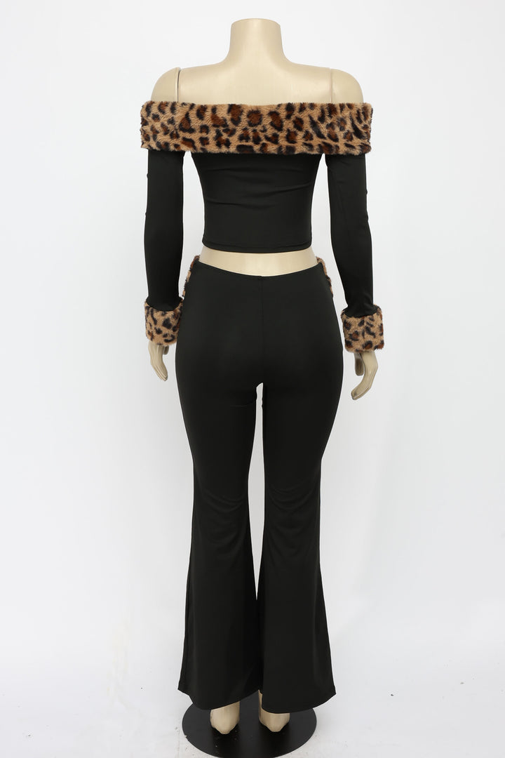 Mannequin wearing a black outfit with leopard print accents on a white background