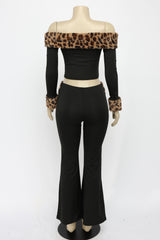 Mannequin wearing a black outfit with leopard print accents on a white background