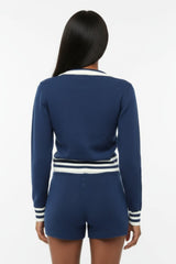 Person wearing a blue outfit with white stripes on a white background