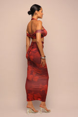 Woman wearing a red patterned dress on a beige background