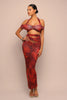 Woman wearing a red dress with a ruched design on a beige background