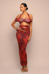 Woman wearing a red dress with a ruched design on a beige background
