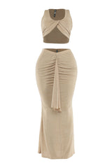 Front view of beige sleeveless two-piece set with draped ruched detail on skirt