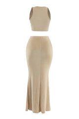 Back view of beige two-piece maxi set highlighting flowy flared hem and body-skimming fit