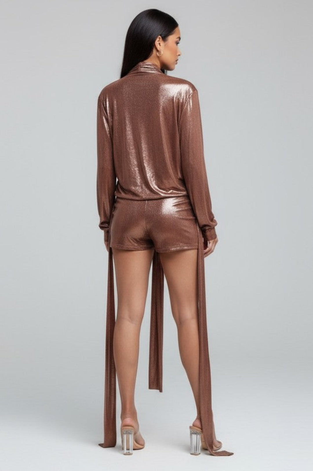 Person wearing a shiny brown outfit on a plain background