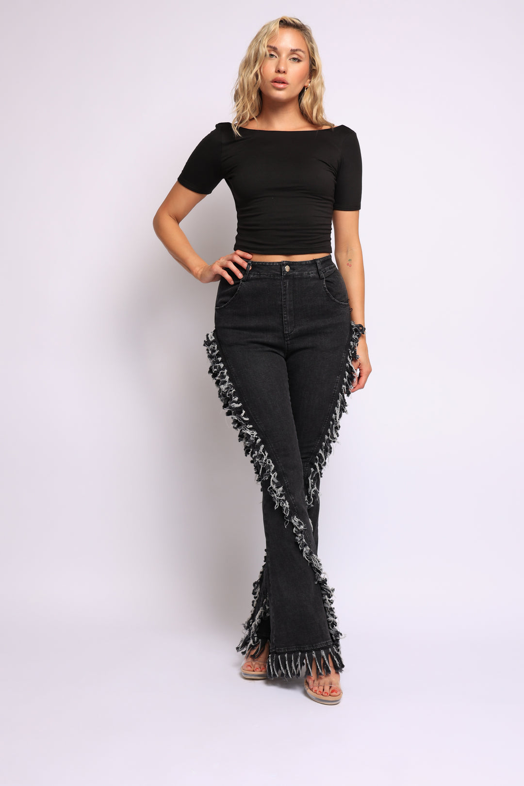 Distressed fringe denim flared pant.