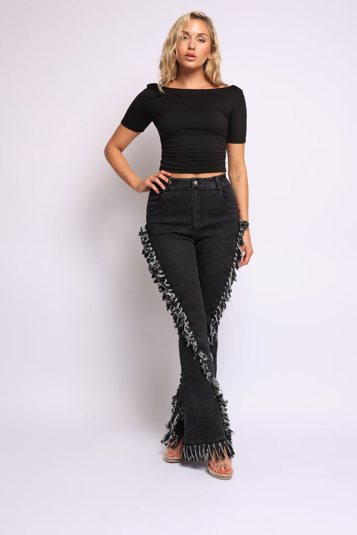 Distressed fringe denim flared pant.