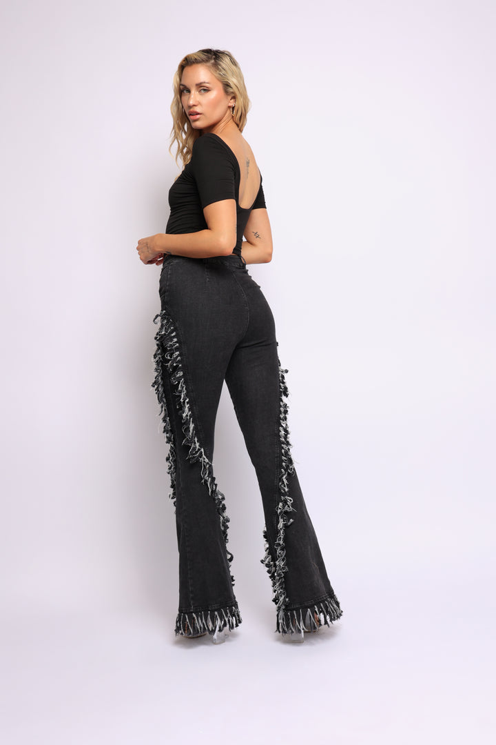 Distressed fringe denim flared pant.