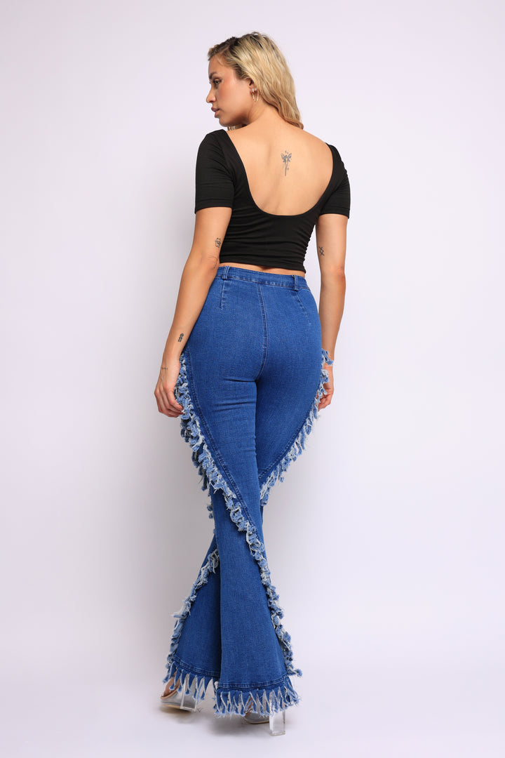 Distressed fringe denim flared pant.