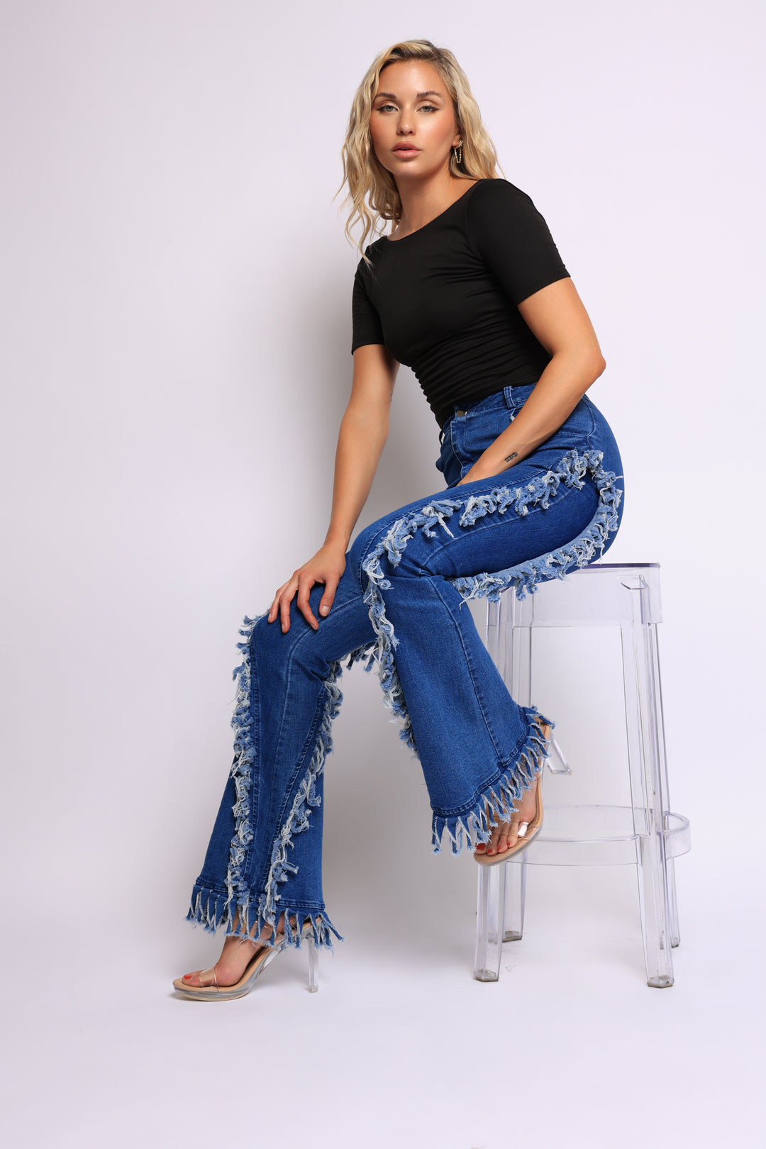 Distressed fringe denim flared pant.