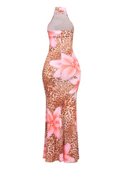 Open back halter maxi dress in bold leopard floral print with curve-accentuating fit and flared hemline
