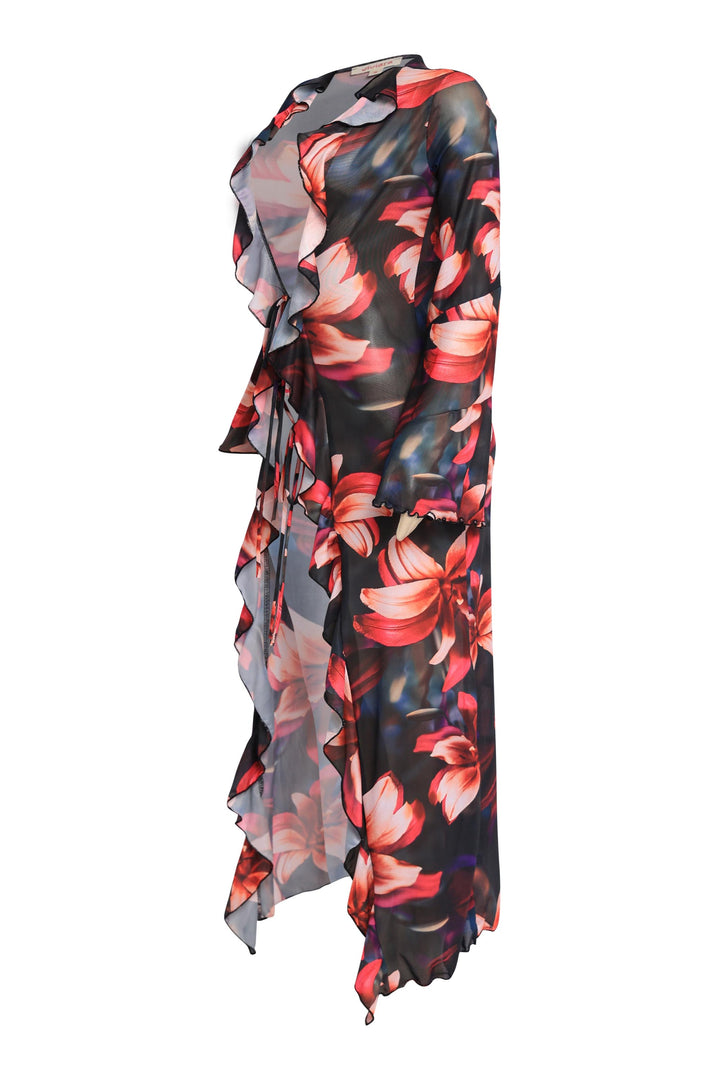 Open front printed chiffon top with double tie closure and flowing ruffle edges styled as a beach cover up or festival fit