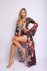 Black mesh top with bold red floral print, deep plunge neckline, and soft ruffle detailing

