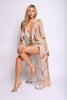 Three-quarter view of soft nude mesh top styled open with cascading ruffles