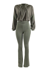 Green tracksuit with hoodie and flared pants on a white background