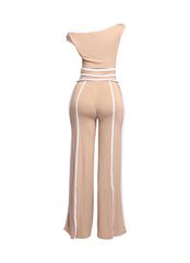 Chic beige off-shoulder top with matching high-waisted wide-leg pants, featuring crisp white accents for a modern look.
