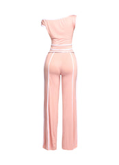 Blush pink and white two-piece pant set featuring an off-shoulder top and wide-leg pants for a stylish yet elegant vibe.