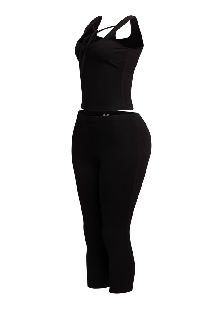 Sophisticated black tank top with a tie-front detail and matching capri pants, ideal for a sleek, fashion-forward vibe.