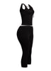 Chic black two-piece set featuring a tie-front crop tank and capri pants, perfect for a bold and versatile look.
