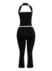 Minimalist yet striking black two-piece set featuring a halter top and cropped capri pants, perfect for nights out.