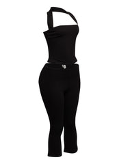 Chic halter neck top paired with figure-hugging capri pants, ideal for a bold and sophisticated outfit.