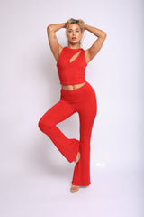Bold red flare pant set with asymmetrical neckline crop top and curve-hugging slim fit

