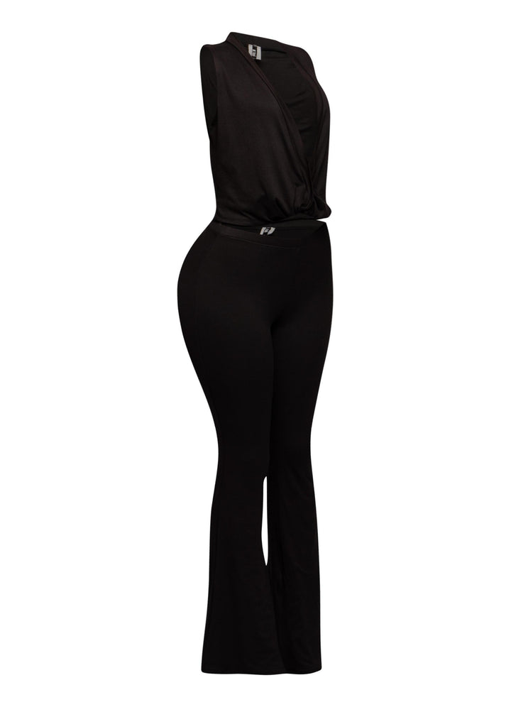 Sleeveless black twist front crop top with curve-hugging pants in stretchy knit