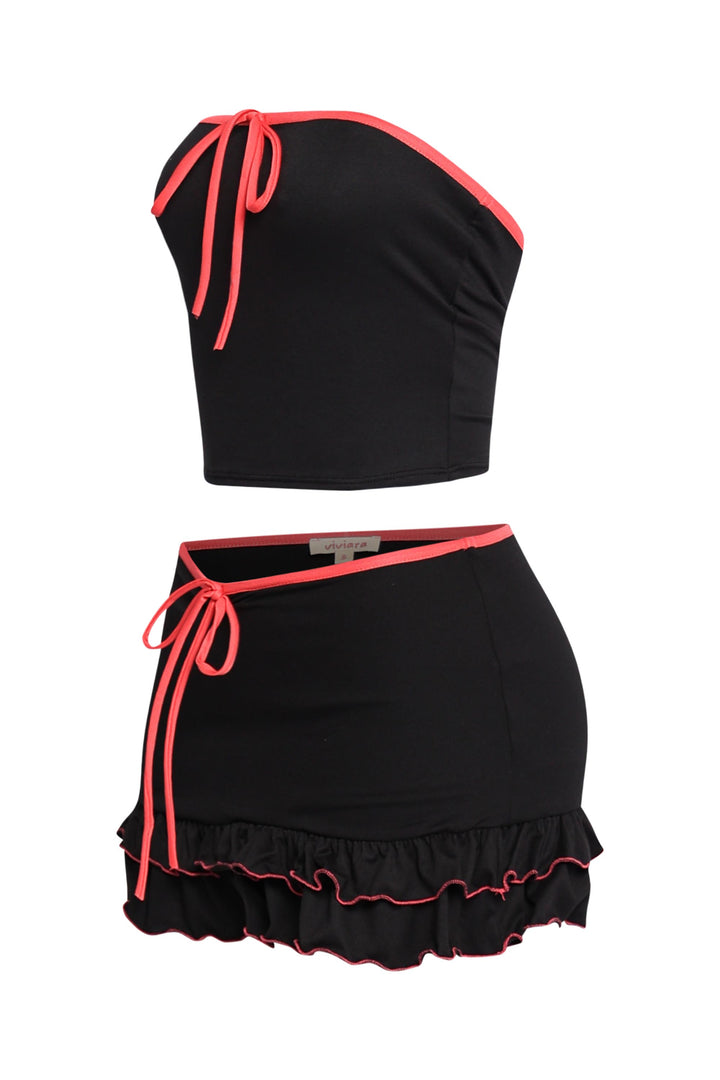 Trendy two-piece black outfit with vibrant pink accents, relaxed fit, and layered ruffle mini skirt