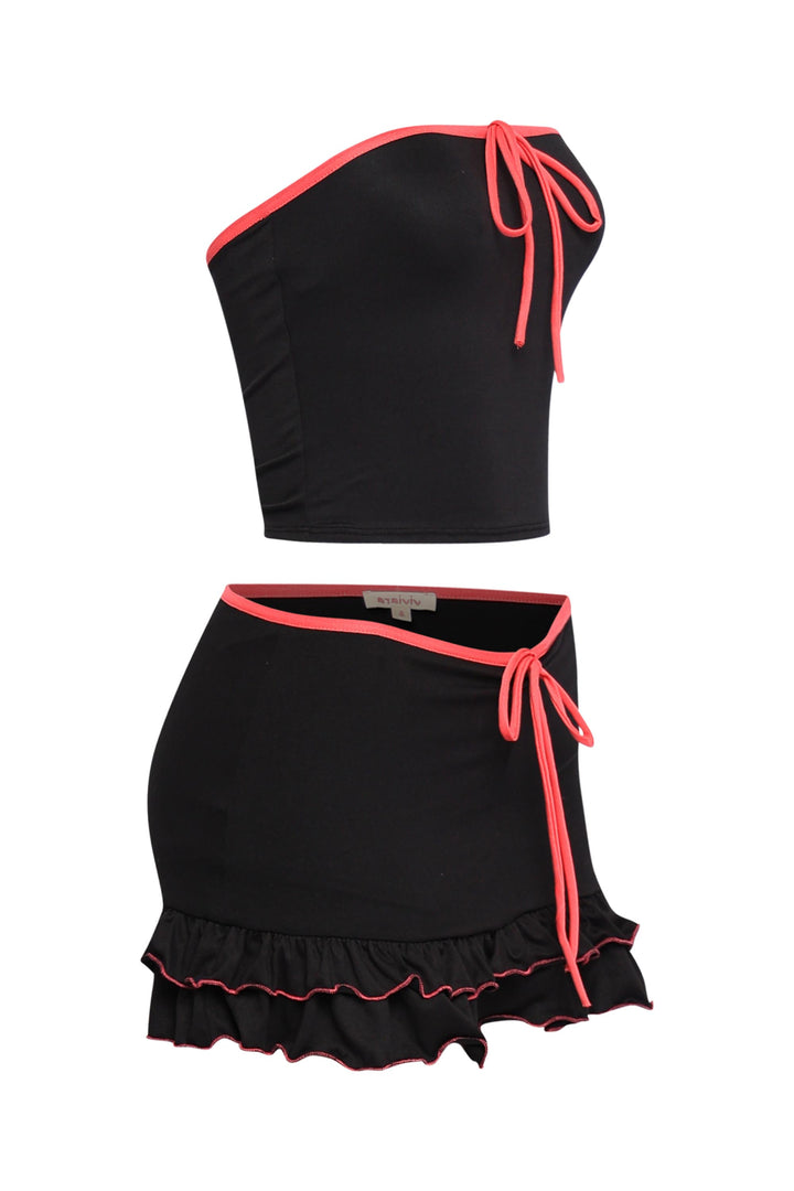 Flirty black skirt set featuring pink drawstring details, soft stretch fabric, and Y2K-inspired silhouette